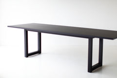 Modern luxury black walnut dining table styled in a modern dining room