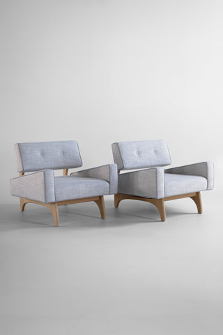 Canadian modern lounge chairs in white oak, pair angled three-quarter with pale grey linen upholstery