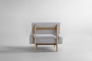 Canadian modern lounge chair in white oak, rear view showing the oak frame and stretcher
