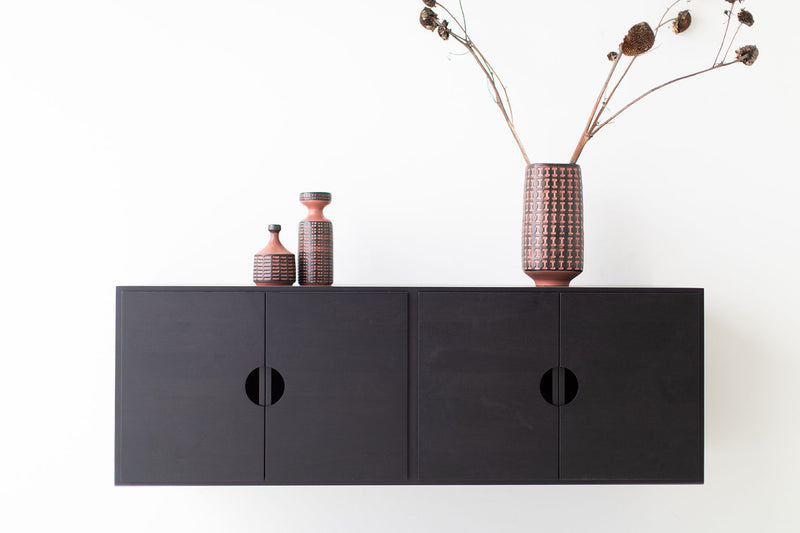 Close-up of the matte finish on the modern walnut cabinet