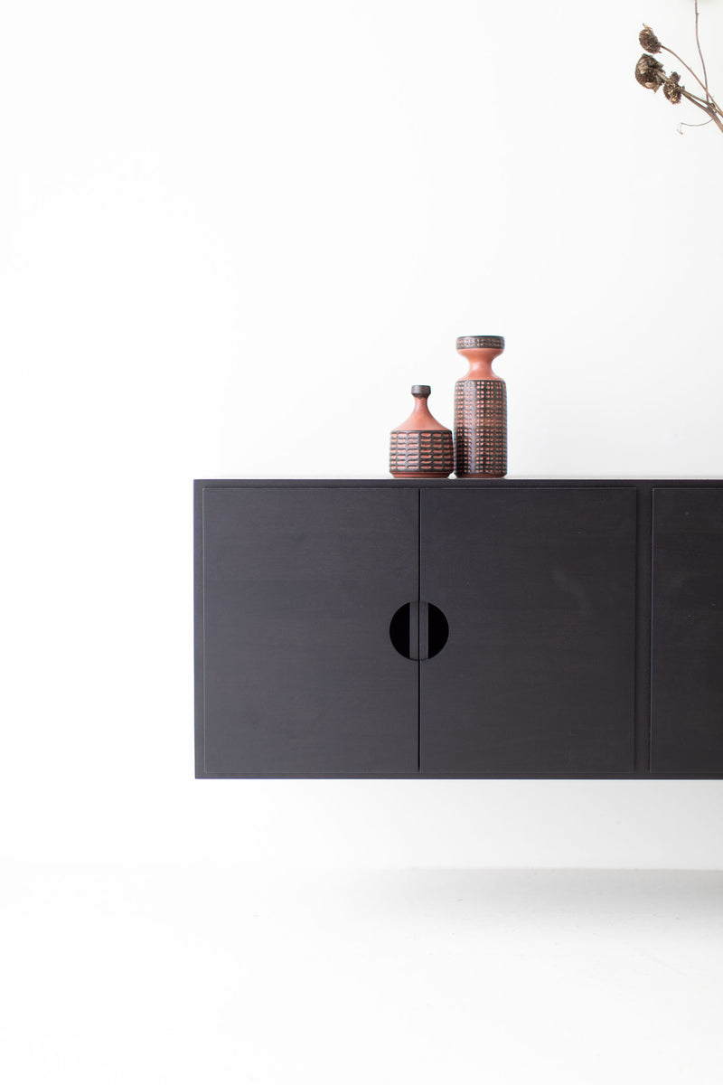 Modern luxury floating walnut cabinet used as a buffet