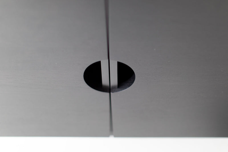 Detail of the modern cabinet's steel base and hardware