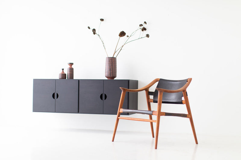 Modern luxury floating walnut cabinet styled with decor on top