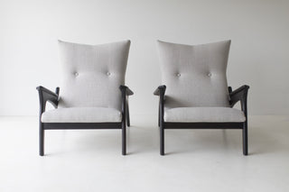 Pair of Frank chairs in dark walnut shown from the front with tufted backs