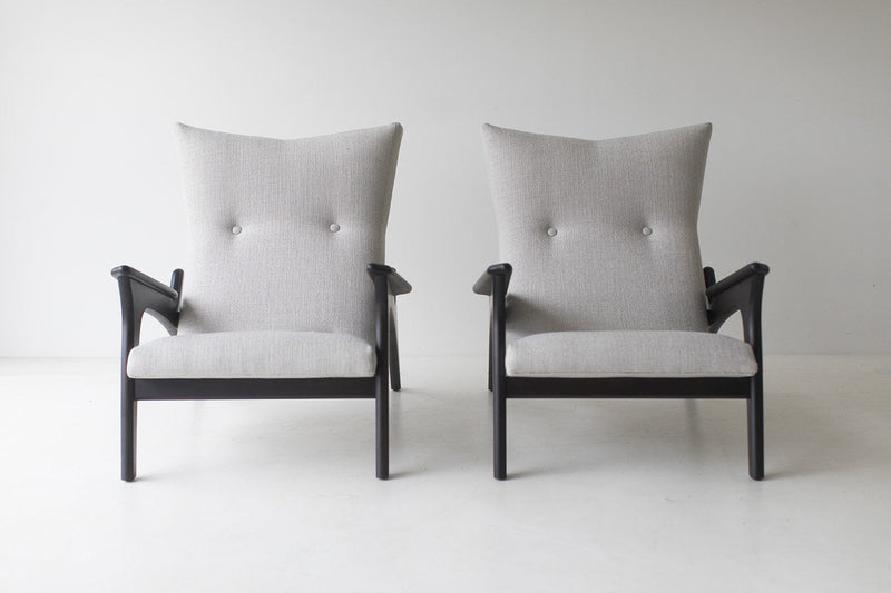Pair of Frank chairs in dark walnut shown from the front with tufted backs