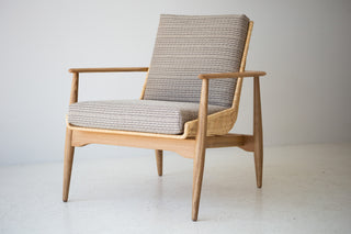 Lawrence Peabody 1806P wicker lounge chair in white oak, front three-quarter view with natural wicker and oatmeal cushions