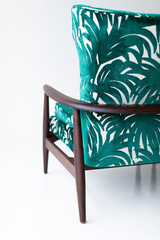Angled view of the Peabody wing chair showing the walnut leg detail