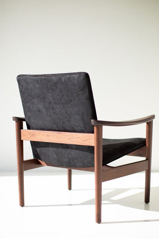 Rear three-quarter view of the walnut 2360P occasional chair with its black upholstered back and open walnut frame