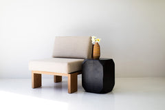 Modern luxury oak lounge chair styled in a bright white room