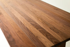 The Toko walnut dining table, angled three-quarter view