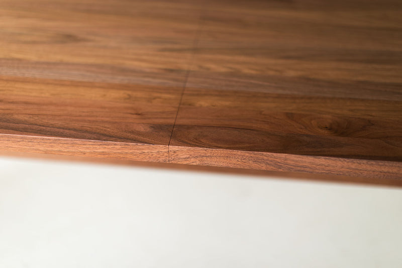 Modern luxury walnut dining table styled with place settings