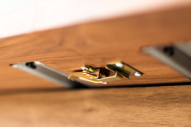 The Toko walnut dining table shown in its shorter configuration