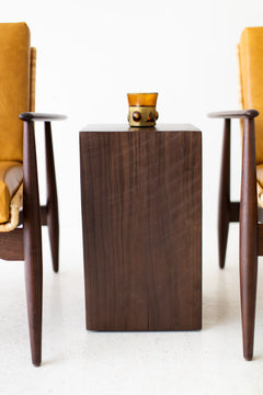 Walnut side table styled in a bright interior
