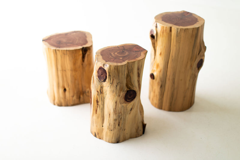 Three natural red cedar stump tables showing their red heartwood tops