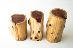Three natural red cedar stump tables showing their tops