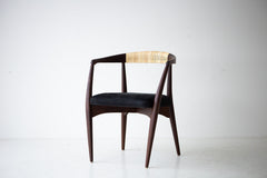 Side profile of the modern Peabody dining chair showing its curved walnut frame