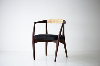 Side profile of the modern Peabody dining chair showing its curved walnut frame