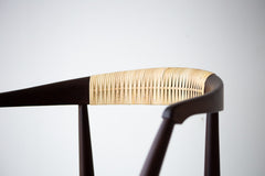 Close-up of the hand-caned back on a solid walnut dining chair