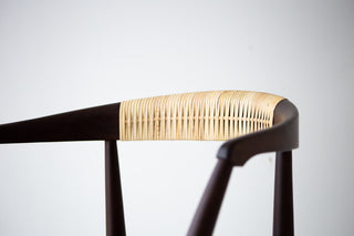 Close-up of the hand-caned back on a solid walnut dining chair