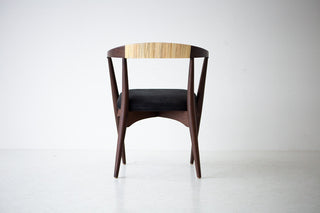 The chair seen from behind, showing the woven cane backrest