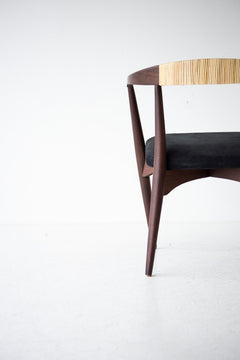 Angled view of the modern Peabody dining chair in walnut and cane