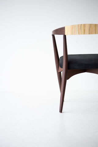 Angled view of the modern Peabody dining chair in walnut and cane