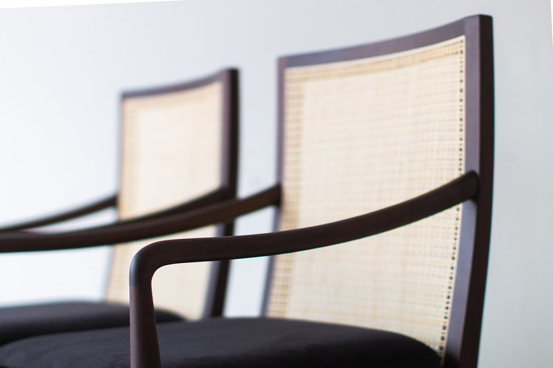 Close-up of the hand-woven cane back framed in walnut