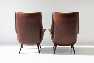 Modern Peabody high back wing chair shown from behind, highlighting the luxury walnut frame