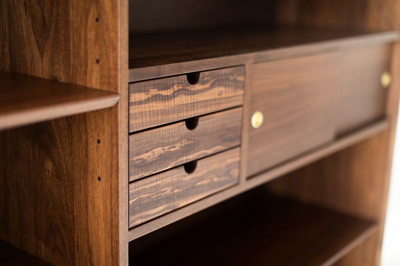 Modern Peabody walnut bookcase styled with books and decor
