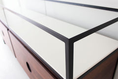 Modern luxury walnut media credenza styled with a television on top