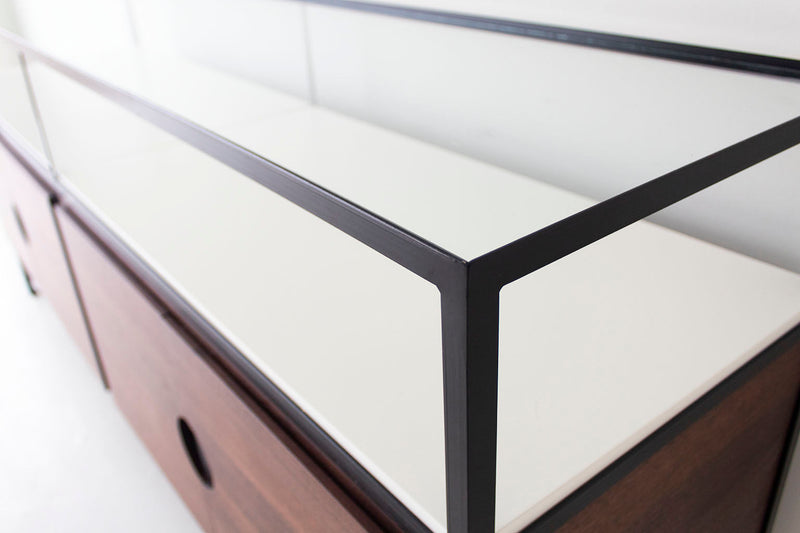 Modern luxury walnut media credenza styled with a television on top