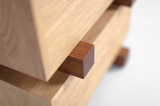 Modern luxury white oak nightstand styled beside a bed with a lamp