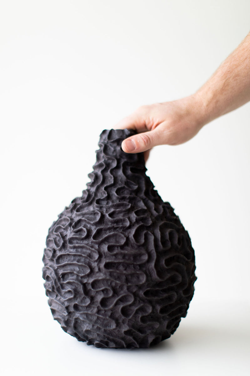 Close-up of the hand-finger-marked surface texture on the vase
