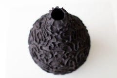 Angled view of the Suzy Goodelman ceramic vase