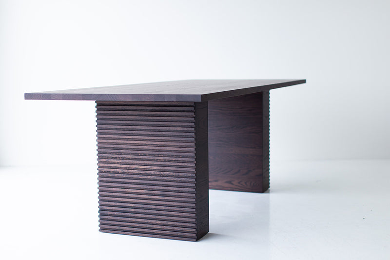 Modern luxury oak dining table styled in a bright interior
