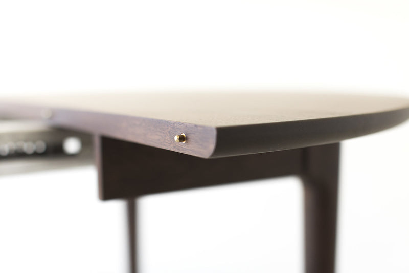Angled view of the Peabody walnut dining table