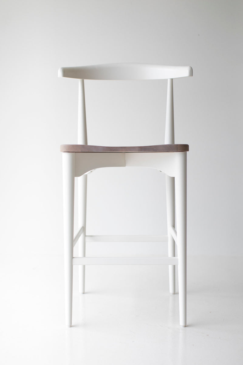 Modern luxury Peabody walnut bar stool at a counter