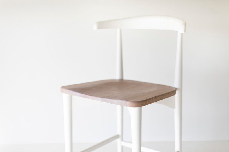 Modern luxury Peabody walnut bar stools styled at a kitchen island