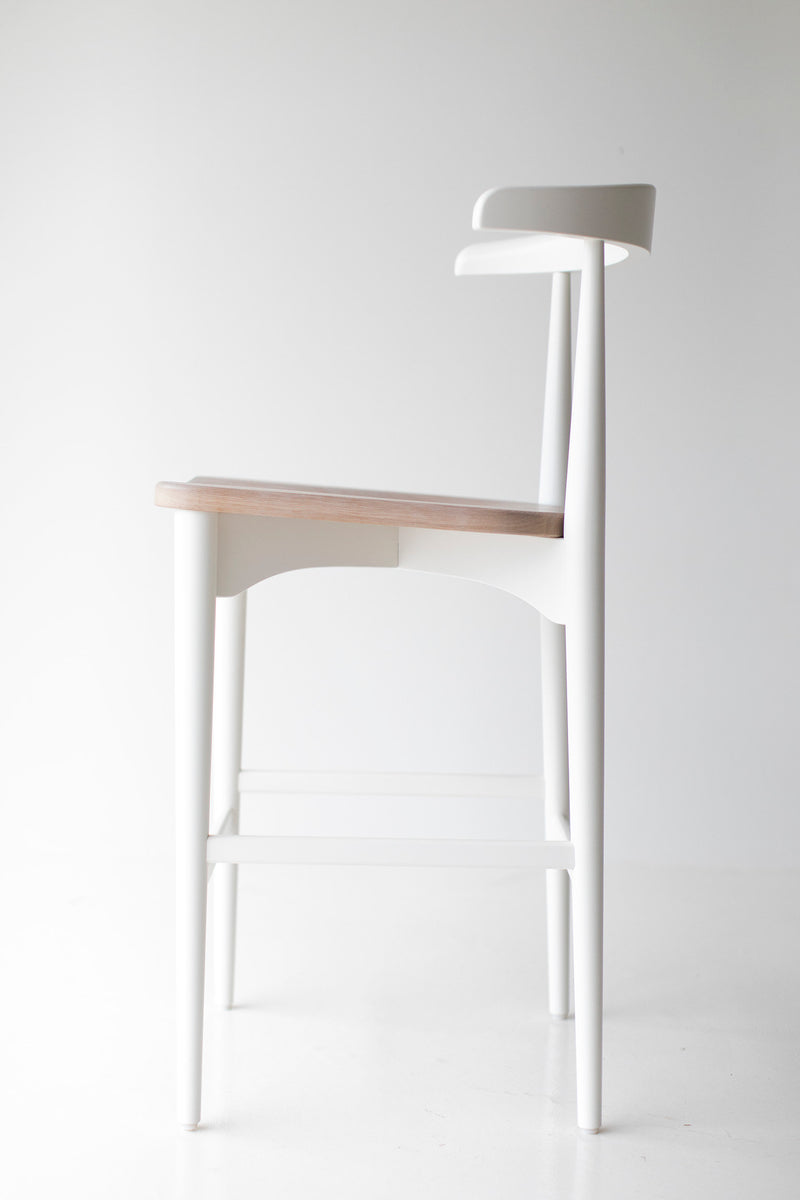 Angled view of the Lawrence Peabody walnut bar stool