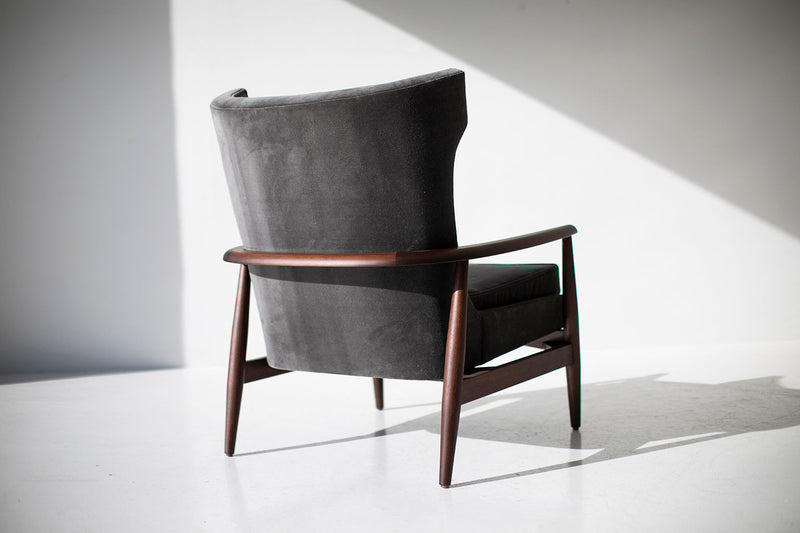 Side profile of the modern Peabody wing chair in walnut and velvet