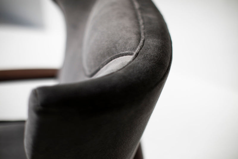 Detail of the solid walnut frame on the wing chair