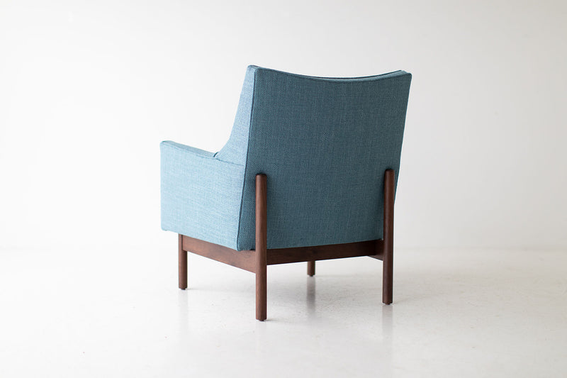 Side profile of the modern Peabody bracket back lounge chair in walnut