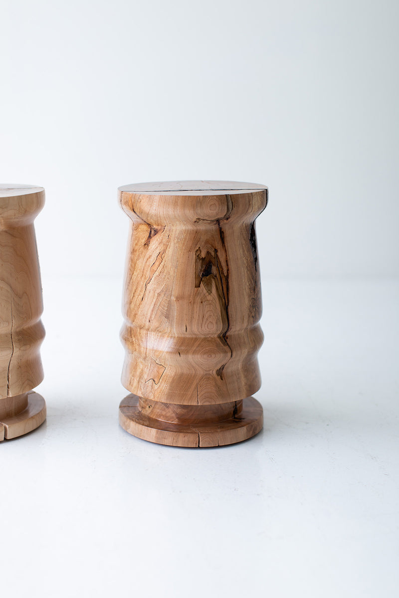 Modern maple end table used as a nightstand