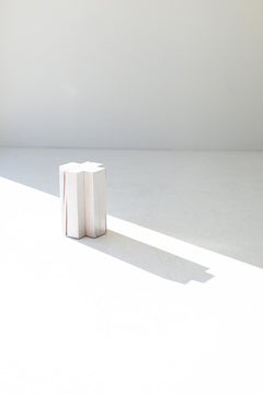 Modern maple side table used as a nightstand