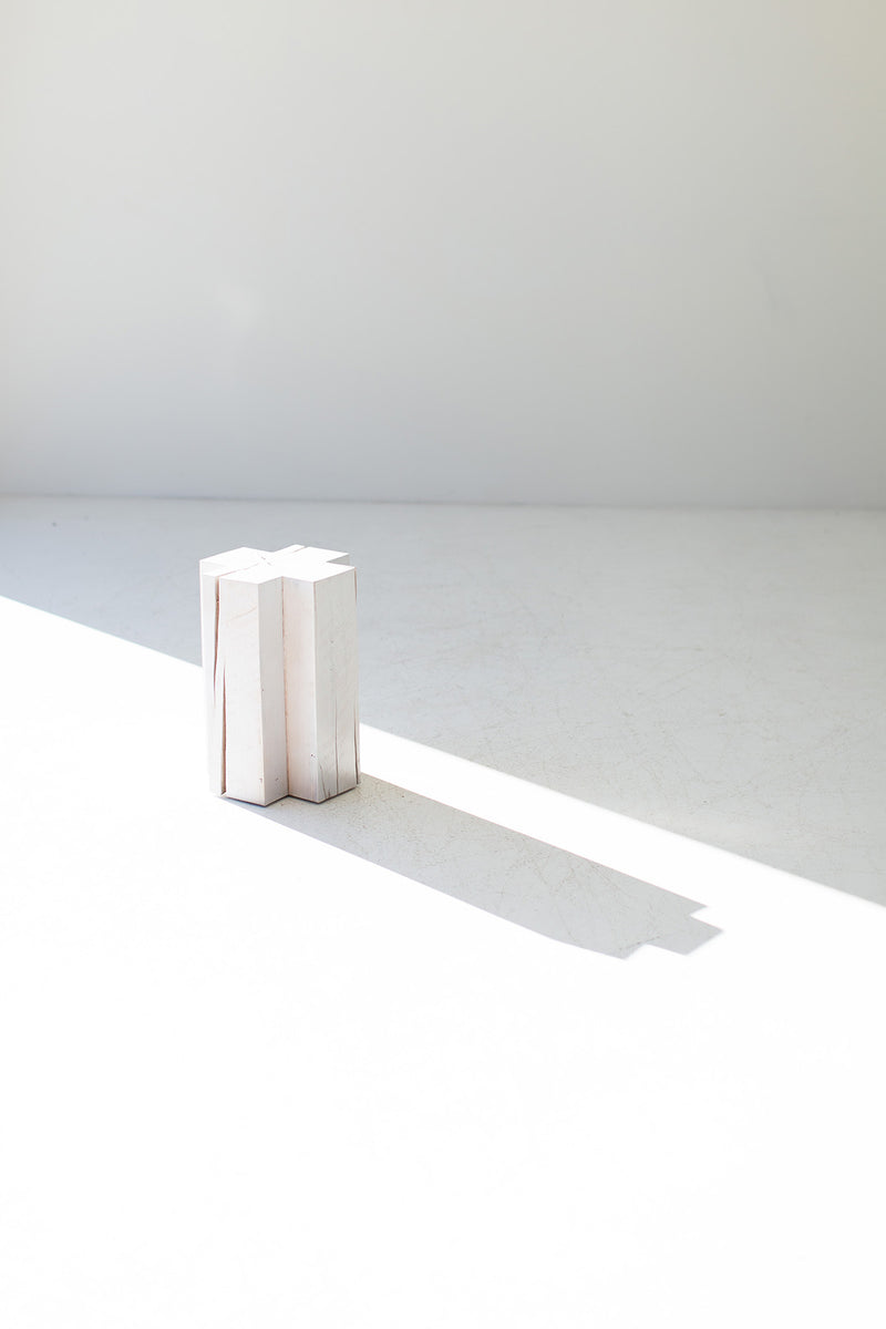 Modern maple side table used as a nightstand