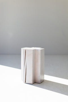 Modern luxury whitewashed maple side table in a bright interior