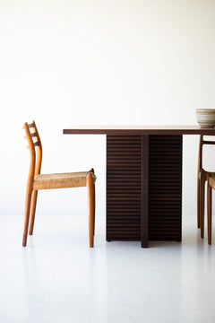 Angled view of the modern Cicely walnut dining table