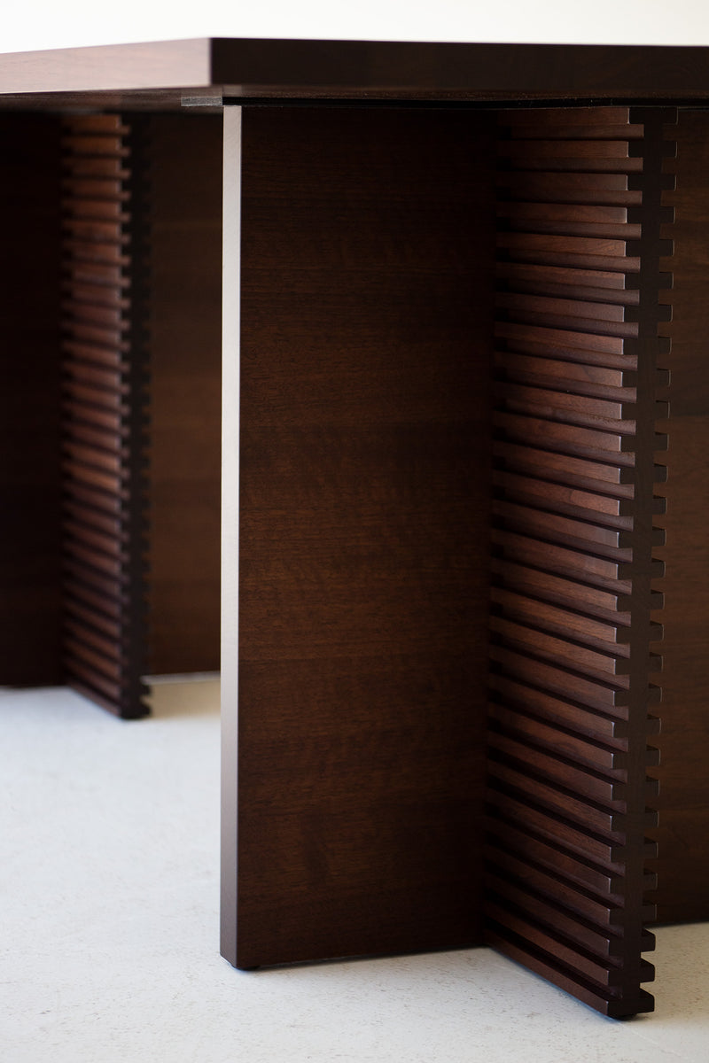 Modern luxury walnut dining table styled with chairs in a dining room