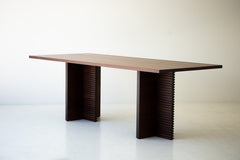 Modern luxury walnut dining table in a bright dining space