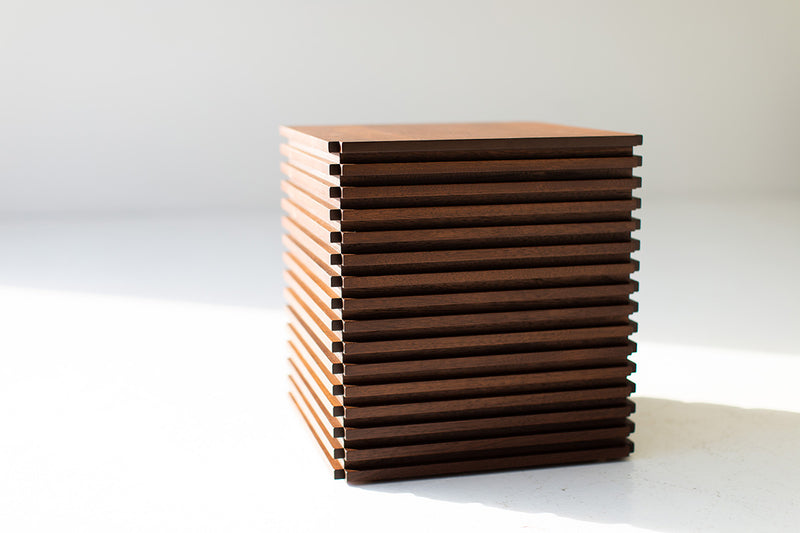 Modern walnut end table in a bright interior